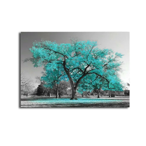 A vibrant turquoise tree stands out against a black-and-white park background, creating a striking and surreal visual contrast.