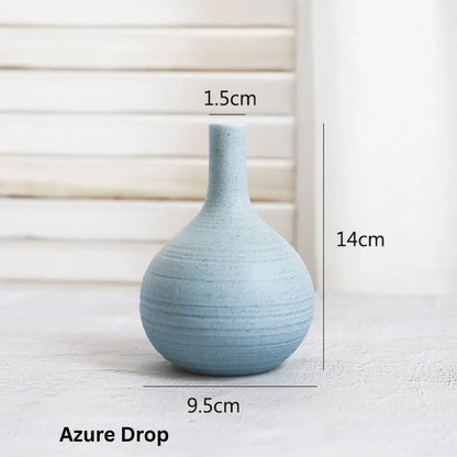 A blue ceramic vase, named "Azure Drop," measures 14cm tall and 9.5cm wide, displayed with a textured background.