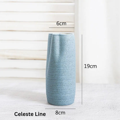 A textured light blue ceramic vase, measuring 19cm tall and 8cm wide, displayed against a soft background.