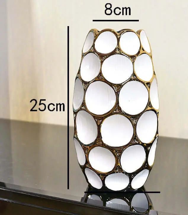 Elegant white vase with a gold circular design, measuring 25cm tall and 8cm wide, displayed on a dark surface. 