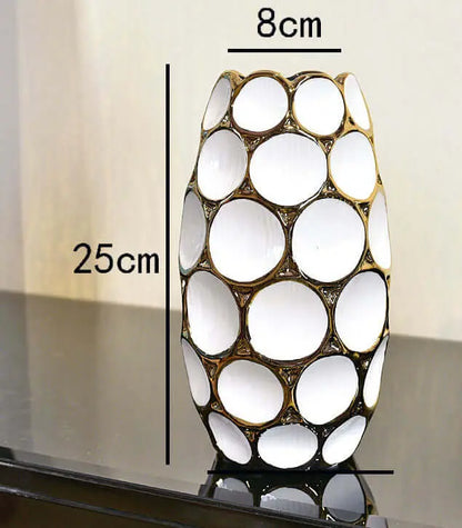 Elegant white vase with a gold circular design, measuring 25cm tall and 8cm wide, displayed on a dark surface. 